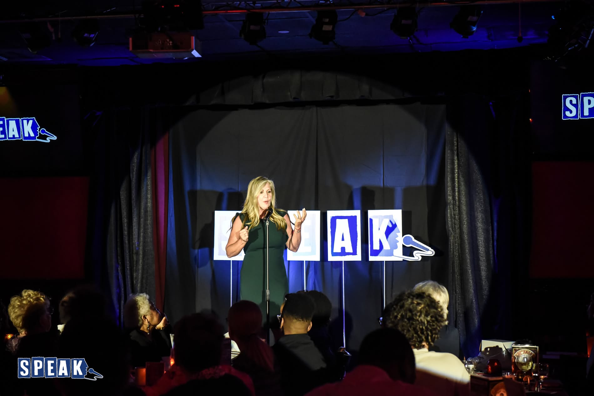 Sharon Fekete speaking on stage at a SPEAK event
