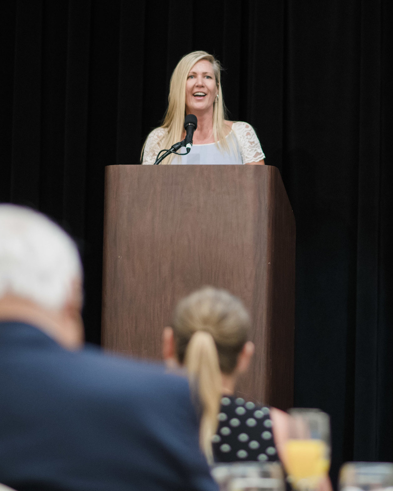 Sharon Fekete speaking at a podium during an awards event