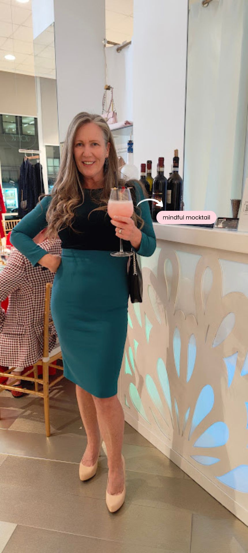 Sharon Fekete holding a zero-proof mocktail at a corporate event